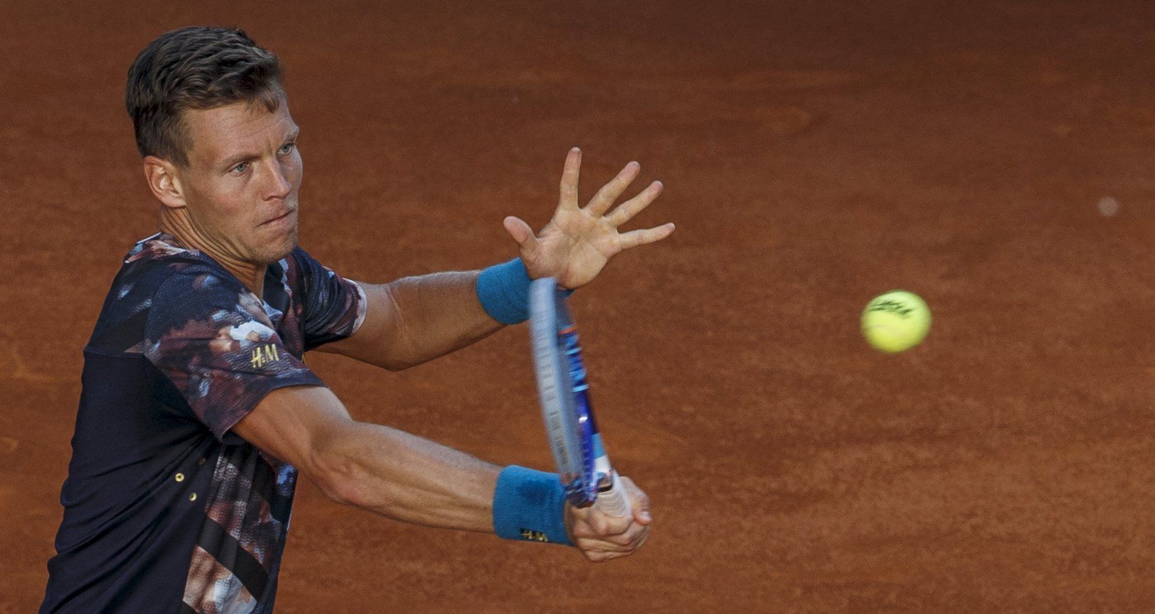 Berdych of the Czech Republic returns a forehand to Isner of the U.S. during their quarterfinal match at the Madrid Open tennis tournament in Madrid