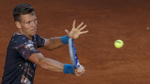 Berdych of the Czech Republic returns a forehand to Isner of the U.S. during their quarterfinal match at the Madrid Open tennis tournament in Madrid