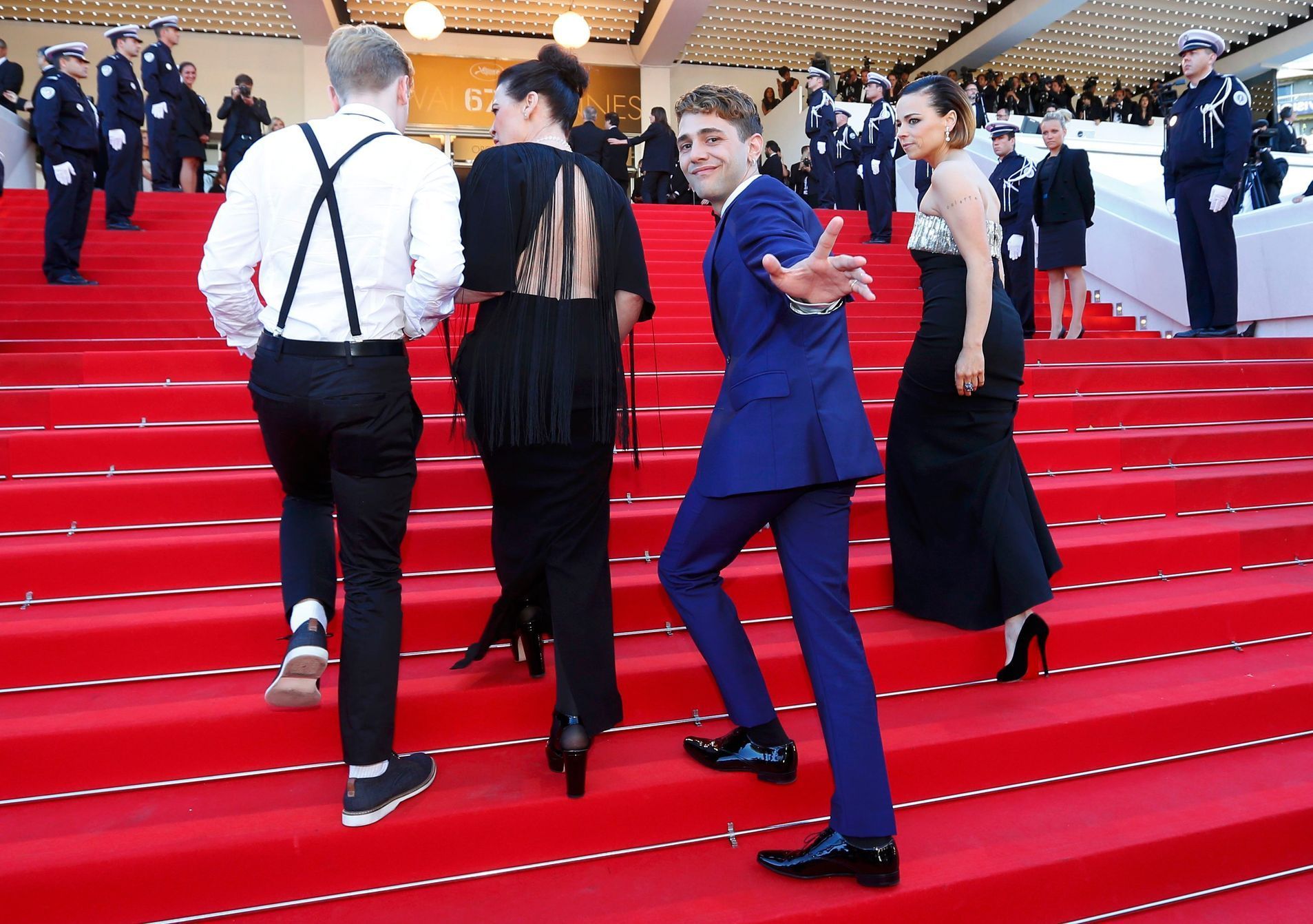 Director Xavier Dolan and cast members of the film &quot;Mommy&quot;, pose on the red carpet as they arrive at the closing ceremony of the 67th Cannes Film Festival