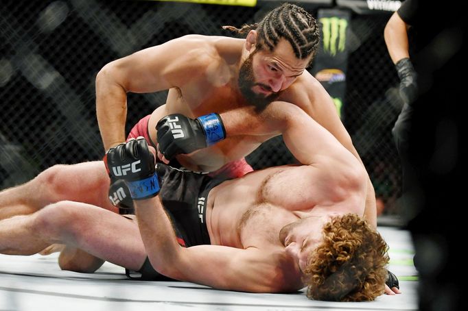 Jul 6, 2019; Las Vegas, NV, USA; Jorge Masvidal (red gloves) punches Ben Askren (blue gloves) at T-Mobile Arena. Jorge Masvidal set a new record for the fastest knockout