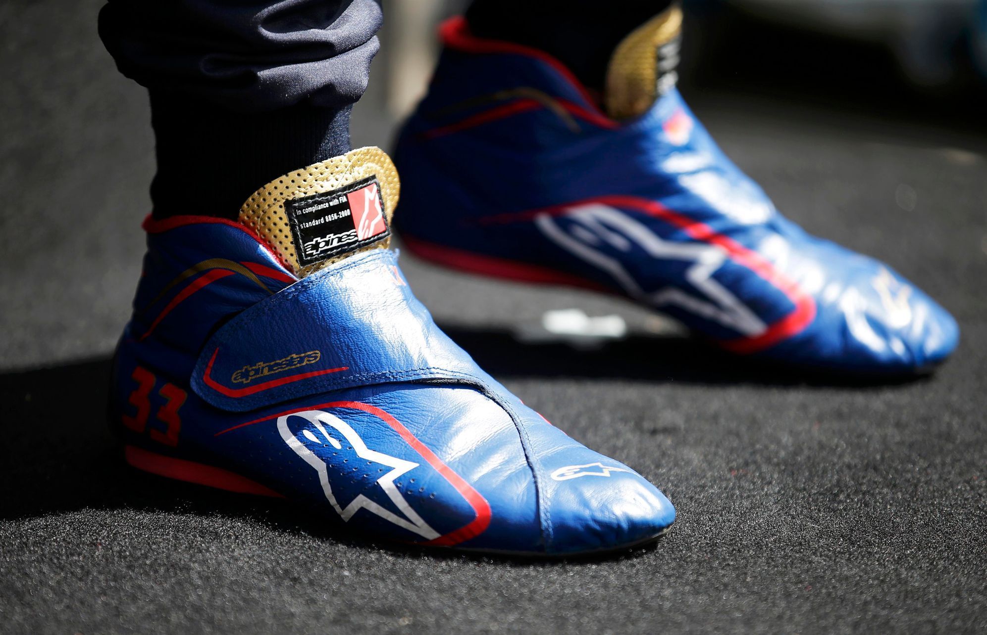 The racing boots of Toro Rosso Formula One driver Max Verstappen of the Netherlands is seen during a photo session before the Australia Formula One Grand Prix, at Melbourne's Albert Park Track