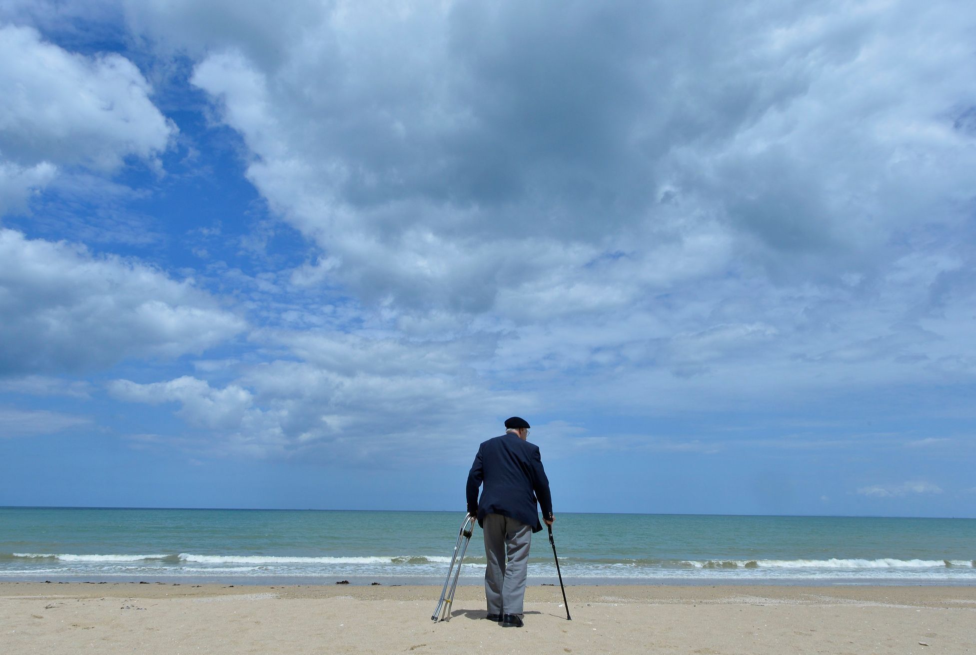 British D-Day veteran, Gordon Smith, 90, from Wiltshire, walks on Sword Beach at Hermanville-sur-Mer on the Normandy coast