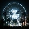 Concertgoers walk by the ferris wheel at the Coachella Valley Music and Arts Festival in Indio