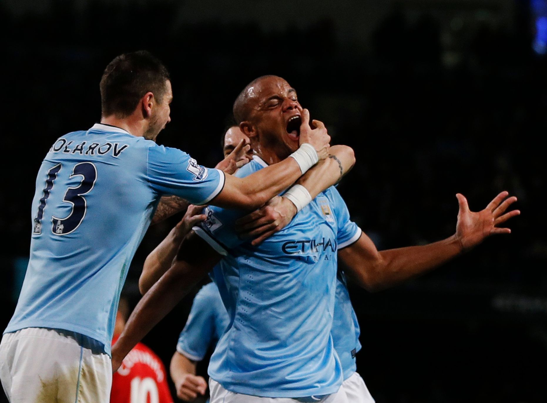 Manchester City's Kompany celebrates with teammates after scoring a goal against Liverpool during their English Premier League soccer match in Manchester
