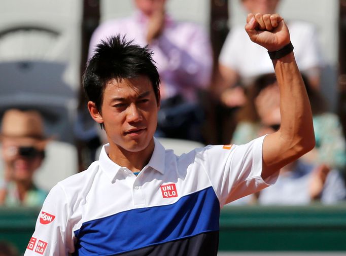 Kei Nishikori of Japan celebrates after defeating Paul-Henri Mathieu of France during their men's singles match at the French Open tennis tournament at the Roland Garros