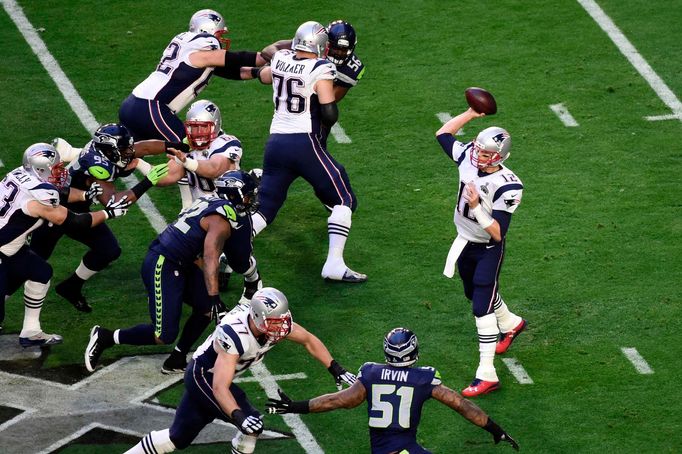 Feb 1, 2015; Glendale, AZ, USA; New England Patriots quarterback Tom Brady (12) throws a pass during the first quarter against the Seattle Seahawks in Super Bowl XLIX at