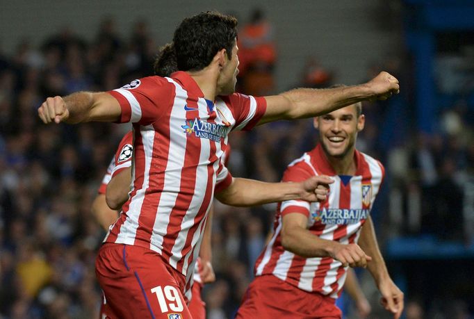 Atletico Madrid's Diego Costa celebrates his penalty goal against Chelsea with team mate Mario Suarez (R) during their Champions League semi-final second leg soccer match