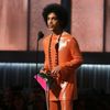 Prince presents the award for album of the year at the 57th annual Grammy Awards in Los Angeles