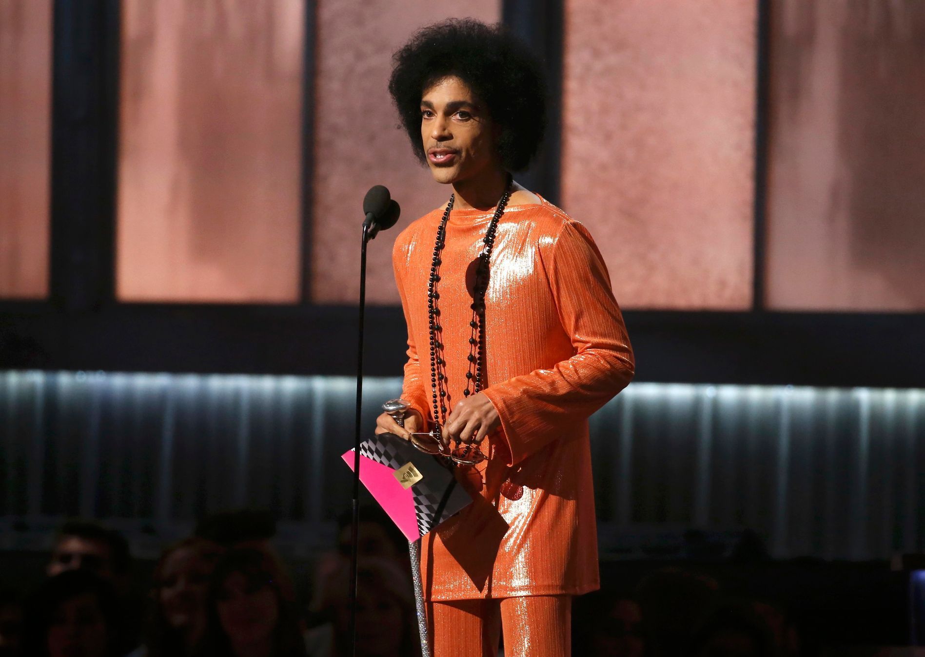 Prince presents the award for album of the year at the 57th annual Grammy Awards in Los Angeles