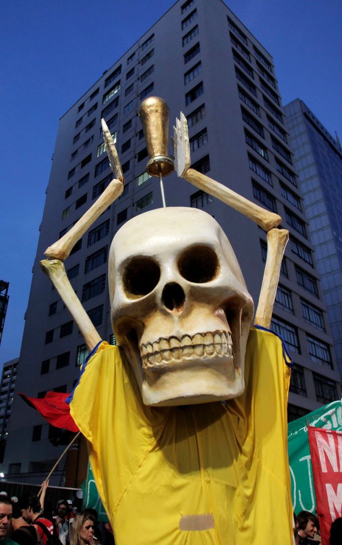 A figure holds a fake World Cup trophy during a a protest against 2014 World Cup in Sao Paulo May 15, 2014. Brazilians opposed to the World Cup and the public funds spent