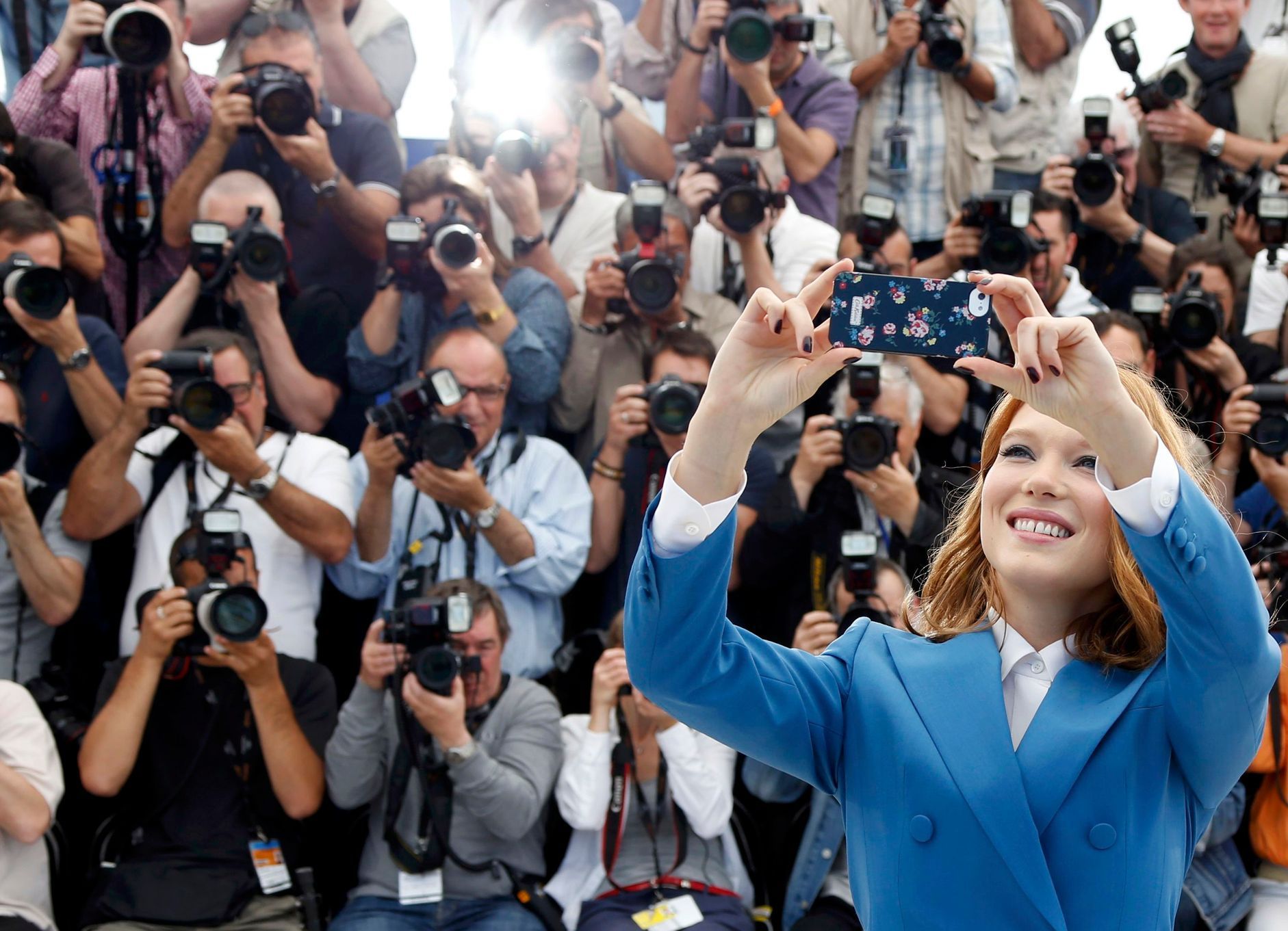 Cast member Lea Seydoux takes a selfie with a mobile phone as she poses during a photocall for the film &quot;Saint Laurent&quot; in competition at the 67th Cannes Film Festival in Cannes