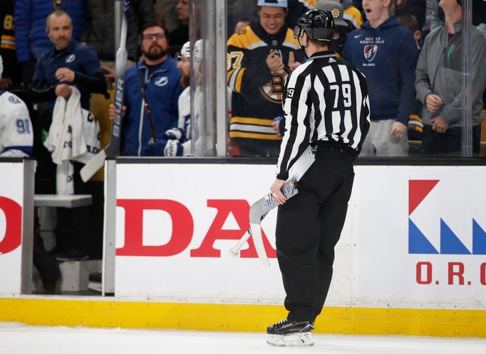 Feb 28, 2019; Boston, MA, USA; The referee carries the broken goal stick smashed in frustration by Tampa Bay Lightning goaltender Louis Domingue (not pictured) off the ic