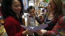 Jaidon Santos-Volpe (C) presents a Valentine's Day card to his two mothers Theresa Volpe (R) and Mercedes Santos during the Valentine's Day Ball at Baker Demonstration School in Wilmette, Illinois, February 13, 2013. Santos and Volpe are a same-sex couple raising two of their biological children as they struggle to get same-sex marriages passed into law in Illinois. Picture taken February 13, 2013. REUTERS/Jim Young (UNITED STATES - Tags: SOCIETY) Published: Bře. 25, 2013, 6:06 odp.