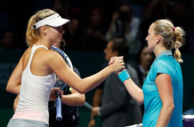 Maria Sharapova of Russia (L) congratulates Petra Kvitova of the Czech Republic during their WTA Finals tennis match at the Singapore Indoor Stadium October 23, 2014. REU