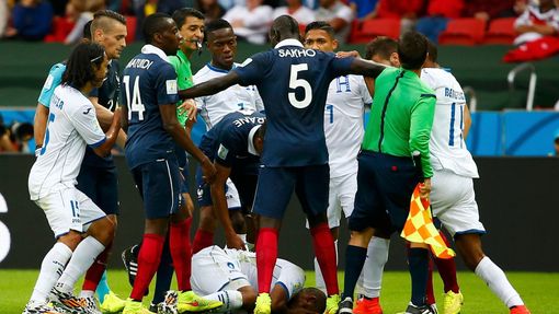 Wilson Palacios of Honduras lies on the pitch during a scuffle with the French players during their 2014 World Cup Group E soccer match at the Beira Rio stadium in Porto
