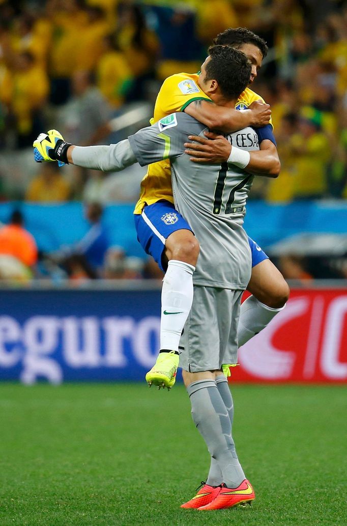 Brazil's Thiago Silva (L) celebrates with teammate Julio Cesar after a goal was scored against Croatia during their 2014 World Cup opening match at the Corinthians arena