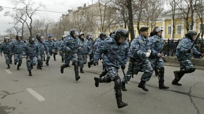 Ruští policisté běží zablokovat demonstrantům přístup do centra města.