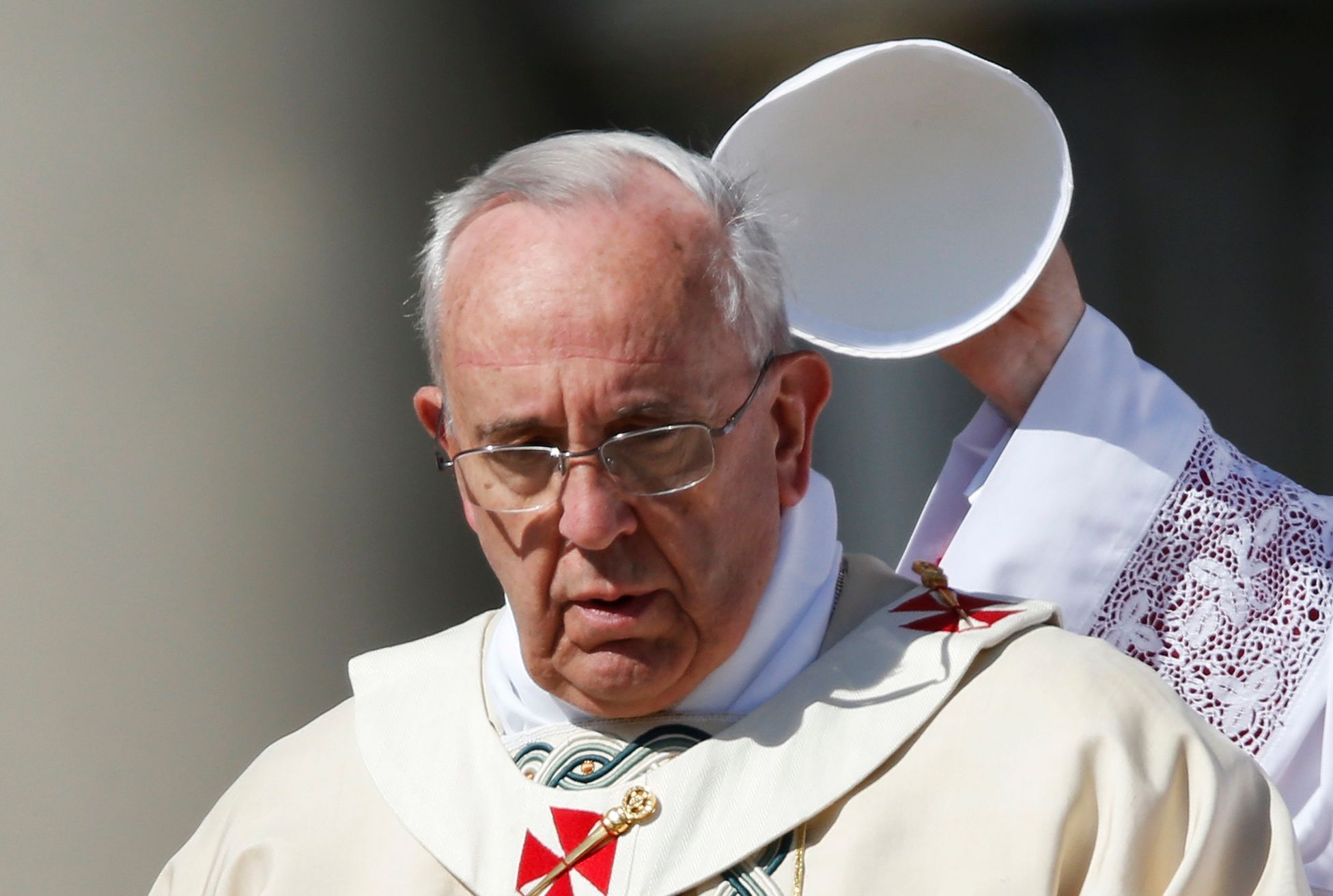 Pope Francis has his hat removed as he leads the Easter mass in Saint Peter's Square at the Vatican
