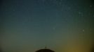 A meteor streaks across the sky over Leeberg hill during the Perseid meteor shower near Grossmugl