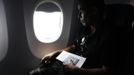 Luis Salgado, nicknamed Chucho, holds his passport as he takes his first flight ever from Havana to Miami, March 13, 2013. Chucho was granted a U.S. visa based on his father's status as legal resident in Texas, and he was reunited in Miami with his father, Jesus Salgado, who had escaped Cuba on a frail boat ten years earlier. The Salgados are among many Cubans taking advantage of Cuba's new travel policy in place since last January, which allows citizens to leave the country with just a passport and no need for much-hated exit visas required since 1961. Picture taken March 13, 2013. REUTERS/Desmond Boylan (CUBA - Tags: POLITICS SOCIETY) Published: Dub. 11, 2013, 1:15 odp.