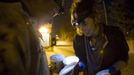 Anna-Rae Douglass (L), 23, and Robin Pickell, practicsing 'freegans' inspect cashew ice-cream in a dumpster behind an organic grocery store in Coquitlam, British Columbia April 5, 2012. A 'freegan' is someone who gathers edible food from the garbage bins of grocery stores or food stands that would otherwise have been thrown away. Freegans aim to spend little or no money purchasing food and other goods, not through financial need but to try to address issues of over-consumption and excess. Picture taken April 5, 2012. REUTERS/Ben Nelms (CANADA - Tags: SOCIETY) ATTENTION EDITORS PICTURE 20 OF 21 FOR PACKAGE 'DUMPSTER DIVING FOR FOOD' Published: Kvě. 15, 2012, poledne