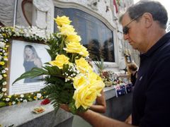 Příbuzní obětí výbuchů z 12. října 2002 kladou květiny k památníku na Bali.