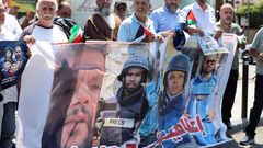 Demonstrators hold a poster during a protest in solidarity with journalists in Gaza, in Sidon
