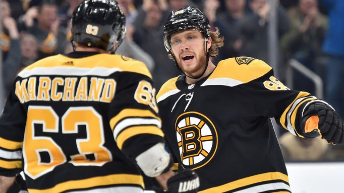 Dec 23, 2019; Boston, Massachusetts, USA;  Boston Bruins right wing David Pastrňák (88) reacts after a goal by left wing Brad Marchand (63) during the first period agains