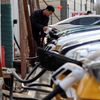 FILE PHOTO: A man charges a car at an EV charging station in Beijing