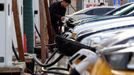 FILE PHOTO: A man holds a charging plug to charge a car at a Smart Charge electric vehicle (EV) charging station in Beijing, China February 2, 2024. REUTERS/Florence Lo/F