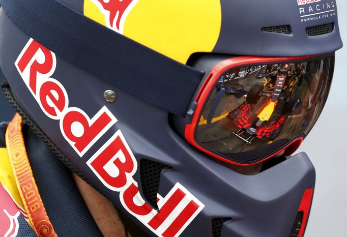 The car driven by Red Bull Racing F1 driver Daniel Ricciardo is reflected in a team members protective goggles during the first practice session at the Australian Formul