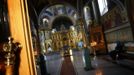 A woman sits in prayers inside the church of archangel Michael in Sochi, the host city for the Sochi 2014 Winter Olympics, February 18, 2013. REUTERS/Kai Pfaffenbach (RUSSIA - Tags: RELIGION SPORT OLYMPICS SOCIETY) Published: Úno. 18, 2013, 7:15 odp.