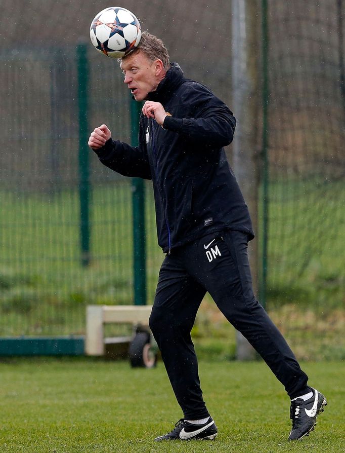 Manchester United's manager Moyes heads a ball during a training session at the club's Carrington training complex in Manchester