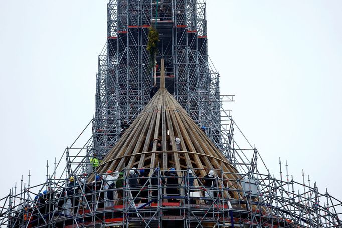 Carpenters install the traditionnal bouquet of flowers to celebrate the end of the reconstruction of the medieval choir framework of the Notre-Dame de Paris Cathedral, wh