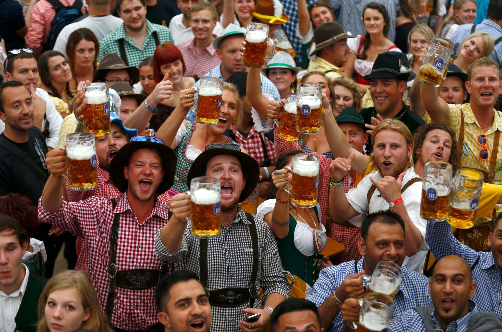 Návštěvníci v krojích připijející svými litrovými sklenicemi piva při otevíracím ceremoniálu 181. ročníku Oktoberfestu v Mnichově.