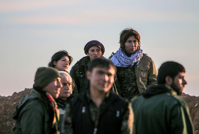 Fighters of the Kurdish People's Protection Units (YPG) gather on a frontline in the southern Ras al-Ain