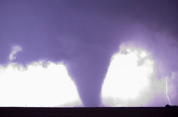 Large Tornado Illuminated by Lightning A bright burst of lightning illuminates a large tornado near La Crosse, Kansas on May 25, 2012.