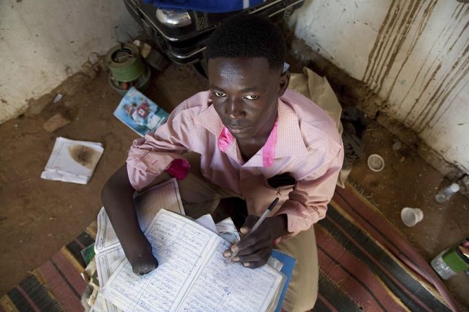 UXO victim Ismael Ibrahim Omar, 20, looks on in his house at the Al Salam camp for displaced persons, in El Fasher