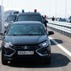 Russian President Vladimir Putin drives a Lada Aura car as he attends a ceremony opening a section of the M-11 "Neva" highway, which connects Moscow and Saint Petersburg,