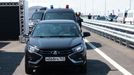 Russian President Vladimir Putin drives a Lada Aura car as he attends a ceremony opening a section of the M-11 "Neva" highway, which connects Moscow and Saint Petersburg,