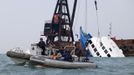 Police boats (L) are seen near a sunken ferry being lifted out of the water after an accident off Hong Kong October 2, 2012. At least 36 people died and dozens were injured when the ferry carrying more than 120 people on a company outing collided with another ferry and sank near an island south of Hong Kong on Monday night in one of the city's worst maritime accidents. REUTERS/Tyrone Siu (CHINA - Tags: DISASTER TRANSPORT) Published: Říj. 2, 2012, 3:03 dop.