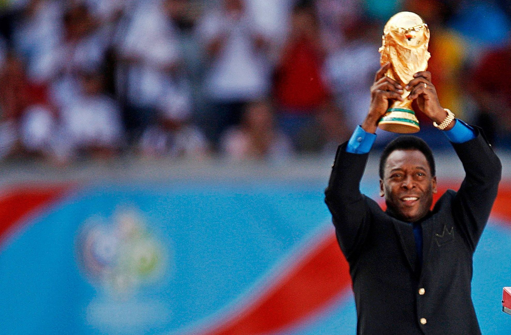 FILE PHOTO: Brazilian soccer legend Pele holds the World Cup trophy during the World Cup 2006 opening ceremony in Munich