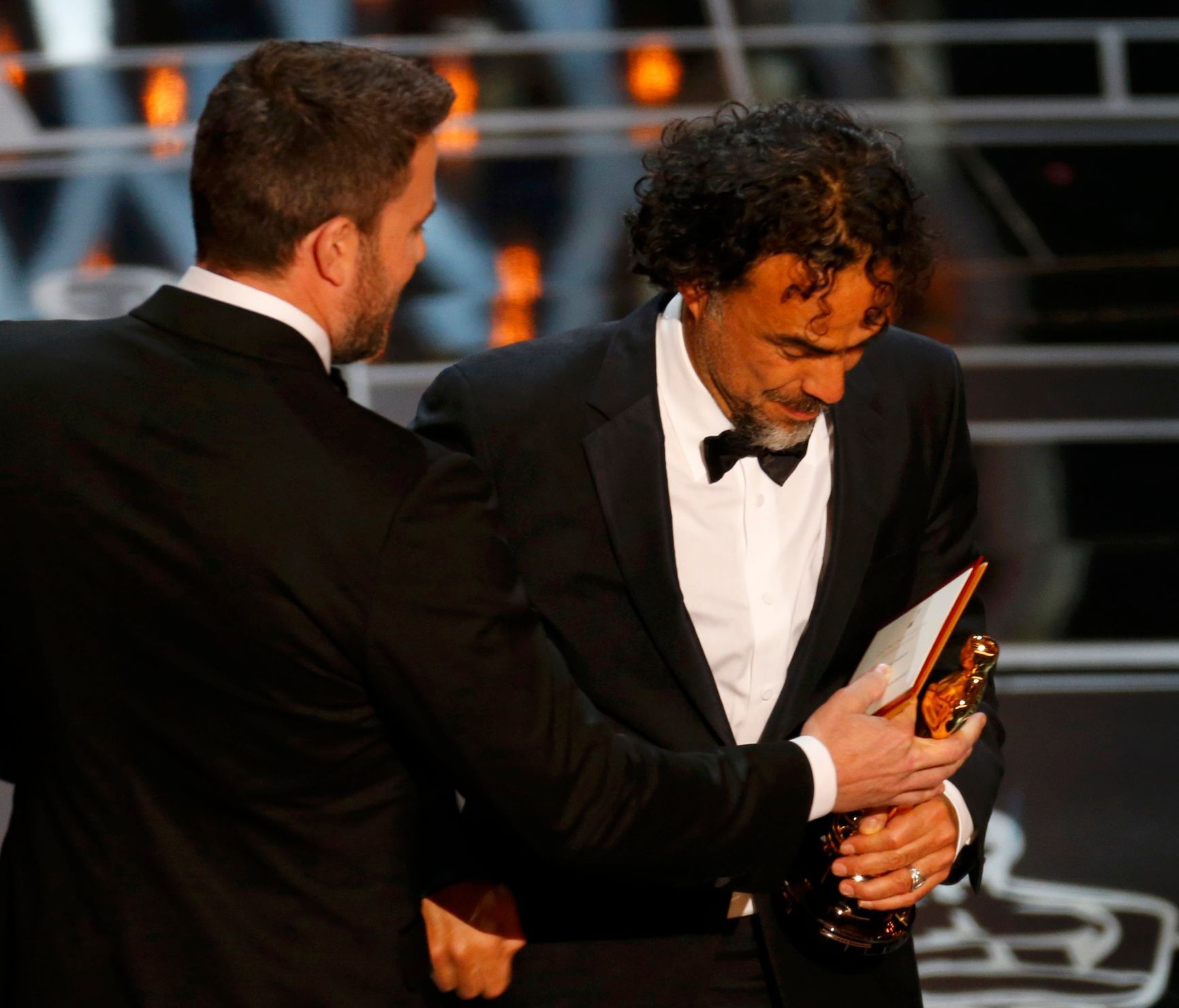Director Alejandro Inarritu is congratulated by Ben Afflick as he accepts the Oscar for Best Director his film &quot;Birdman&quot; at the 87th Academy Awards in Hollywood, California