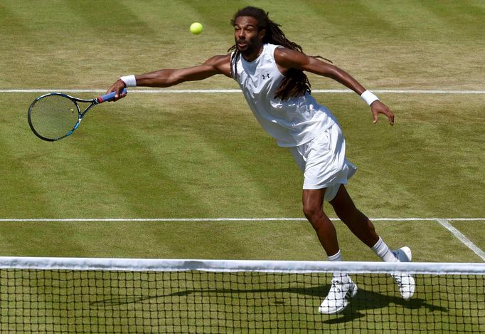 Dustin Brown of Germany hits a shot during his match against Viktor Troicki of Serbia at the Wimbledon Tennis Championships in London