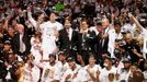 The Miami Heat players, coaches, owner and other staff pose with the Larry O'Brien Championship Trophy (lower L) after their team defeated the San Antonio Spurs in Game 7