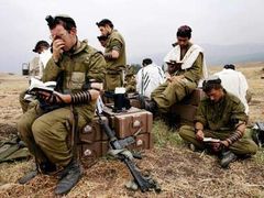 Příslušníci izraelského dělostřelectva, kteří ostřelují jih Libanonu, se modlí na svém stanovišti.