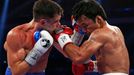 Manny Pacquiao (R) of the Philippines punches Chris Algieri of the U.S. during their World Boxing Organisation (WBO) 12-round welterweight title fight at the Venetian Mac