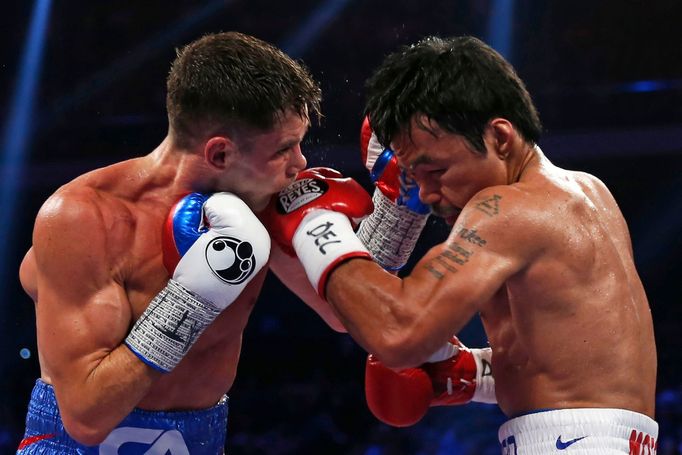 Manny Pacquiao (R) of the Philippines punches Chris Algieri of the U.S. during their World Boxing Organisation (WBO) 12-round welterweight title fight at the Venetian Mac