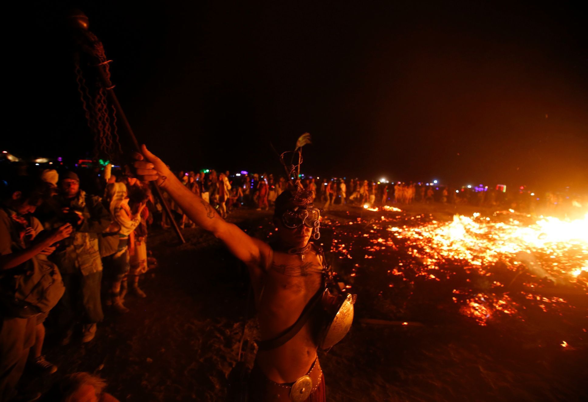 A participant dances as the Temple of Grace burns on the last day of the Burning Man 2014 &quot;Caravansary&quot; arts and music festival in the Black Rock Desert of Nevada
