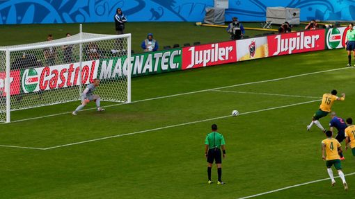 Australia's Mile Jedinak (15) scores a goal from a penalty kick past goalkeeper Jasper Cillessen of the Netherlands during their 2014 World Cup Group B soccer match at th
